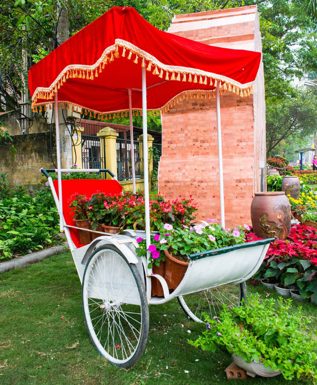 Unusual Garden Ornaments - cart with flower pots and a bright red cover